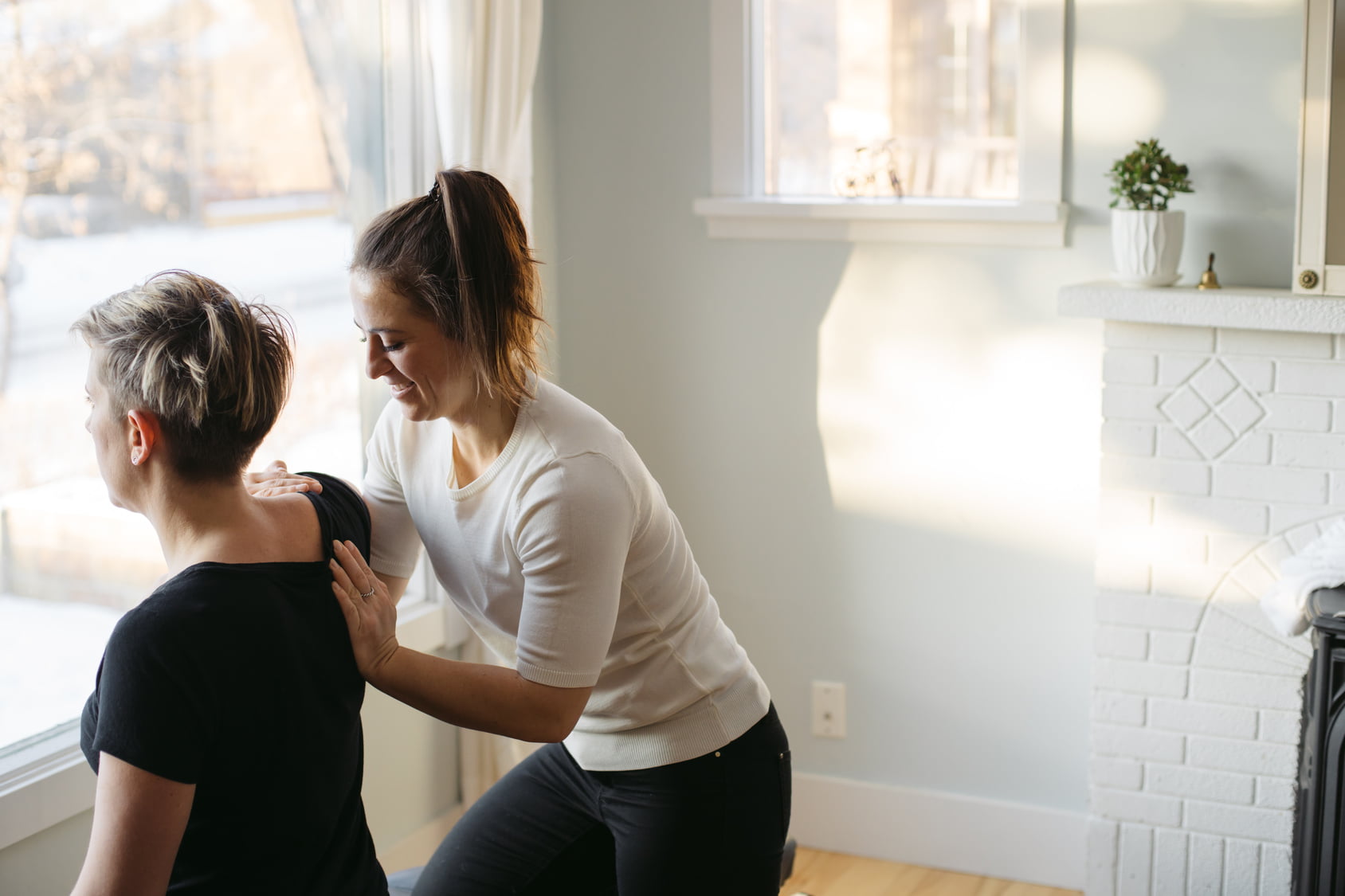 Young woman chiropractor giving treatment
